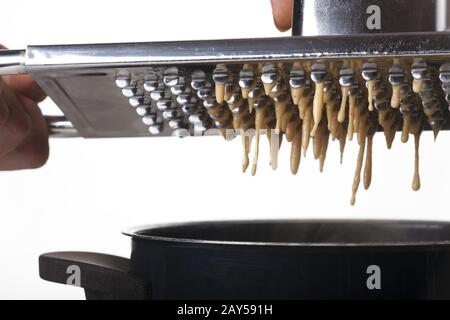 Spätzle plane over a pot Stock Photo