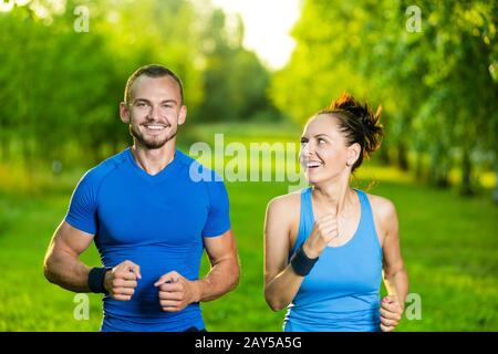 Runners training outdoors working out. City running couple jogging outside. Stock Photo