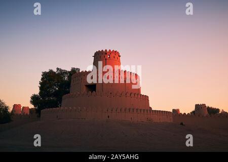 Outside view on towers of historical fort at sunrise. Al Ain, United Arab Emirates Stock Photo