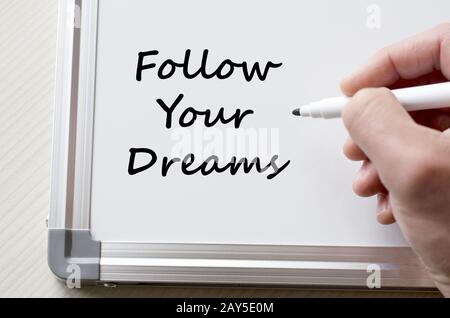 Follow your dreams written on whiteboard Stock Photo