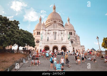 25 July 2019, Paris, France: Crowds of tourists walking near Basilique du Sacre Coeur, on hilltop of Montmartre. Famous travel destination Stock Photo