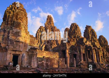 Bayon temple, located in Angkor, Cambodia, the ancient capital city of the Khmer empire. View of the massive stone face towers from the western inner