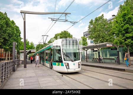 25 July 2019, Paris, France: Passengers at the tram stop in Paris Stock Photo