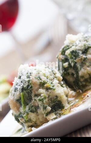 two Italian strangolapreti spinach dumplings Stock Photo