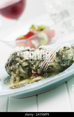 two Italian strangolapreti spinach dumplings Stock Photo