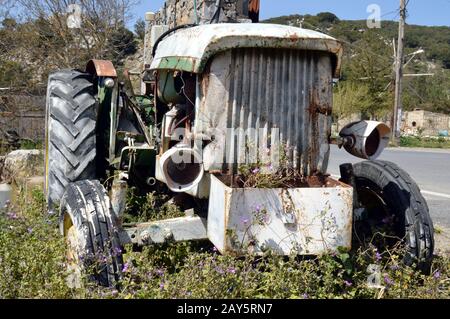 Wreck of an old tractor on a tray of mountain it  Greece Stock Photo