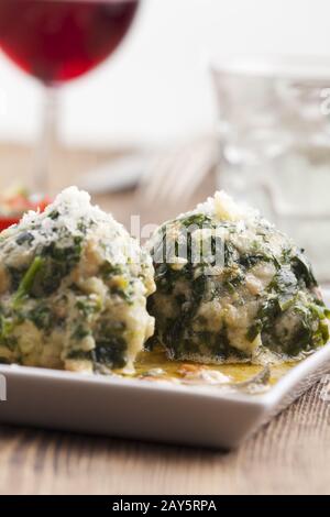 two Italian strangolapreti spinach dumplings Stock Photo