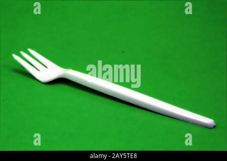 Fork white with plastic snack bar on green bottom. Stock Photo