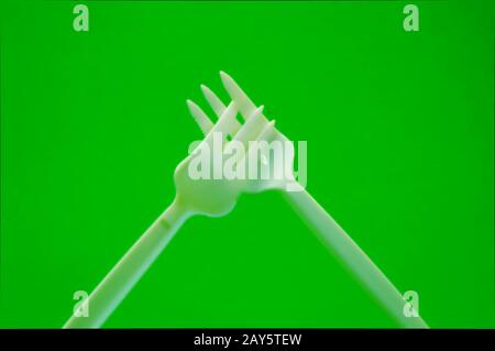 Fork white with plastic snack bar on green bottom. Stock Photo