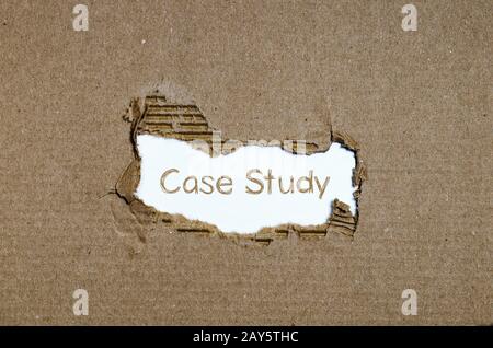 The word case study appearing behind torn paper. Stock Photo