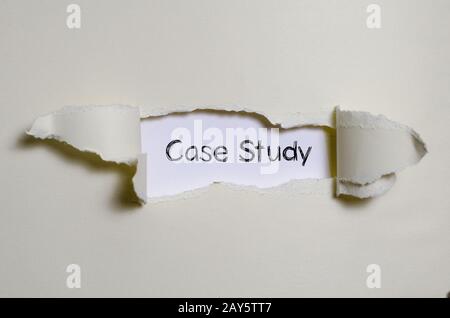 The word case study appearing behind torn paper. Stock Photo