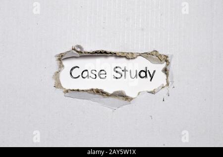 The word case study appearing behind torn paper. Stock Photo