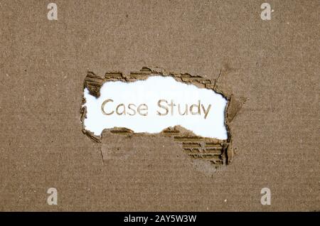 The word case study appearing behind torn paper. Stock Photo