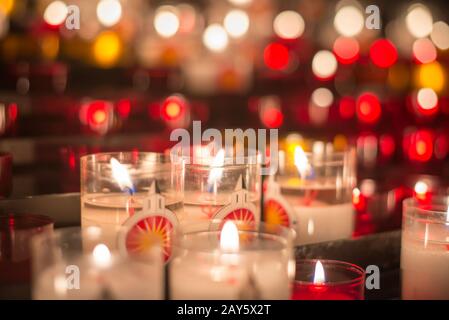 A lot of blurred colorful candles at medieval altar Stock Photo