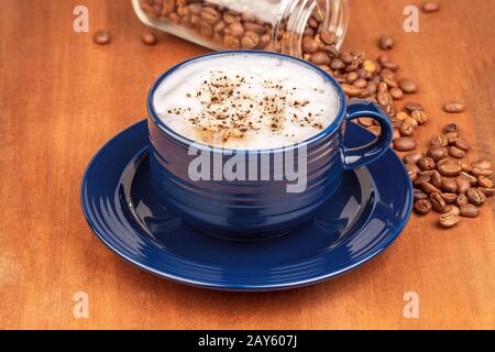 coffee cup and beans, on wooden table Stock Photo