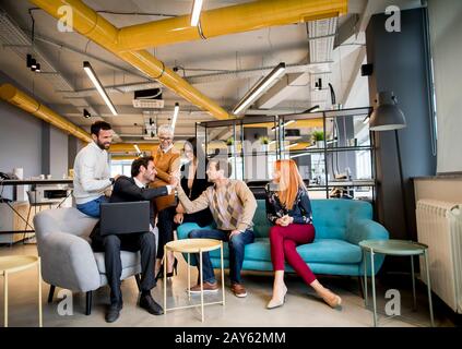 Smiling diverse businesspeople talking together in an office Stock Photo