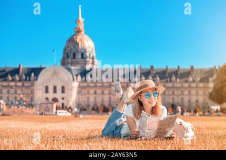 Asian happy girl traveler posing in the square near the Invalides In Paris. Lifestyle and tourism in France Stock Photo