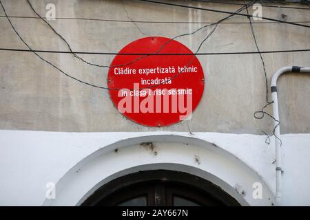 Bucharest, Romania - February 12, 2020: warning sign on an old building reading in Romanian  that the seismic risk of the building is maximum. Stock Photo