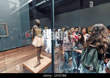 27 July 2019, Orsay museum, Paris, France: Visitors walk through the spacious halls of the Museum and admire the ballerina sculpture of Edgar Degas Stock Photo