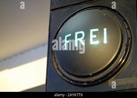 At the entrance to the car park a traffic light with green light. Free parking is available. Stock Photo