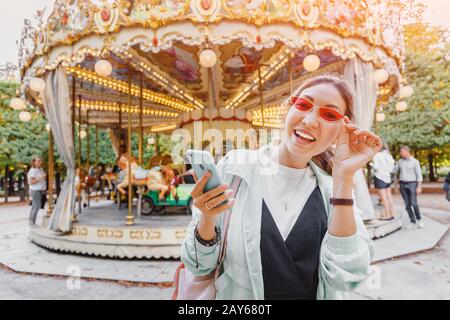 Asian woman with smartphone near Carousel in paris Stock Photo