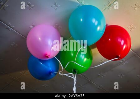 Many multi-colored balloons with helium on ribbons celebration. Stock Photo