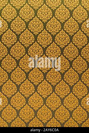 Elegant golden thread repeating pattern over a textile surface. Close up shot. Stock Photo