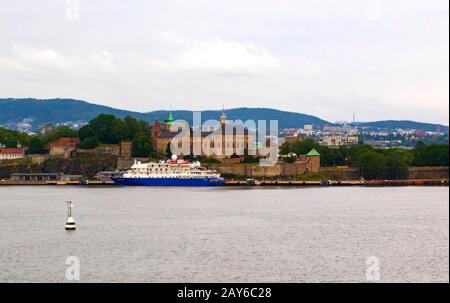 Akershus Festning ,Cruise Terminal and Oslo skyline seen  tfrom the fjord.Akershus Fortress or Castle is a medieval castle in the Norwegian capital Stock Photo