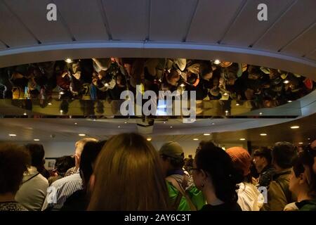 passengers from all over the world eagerly waiting in the lobby reflecting on the ceiling's mirror of Stena Line ferry ship to get off at Oslo Harbour Stock Photo