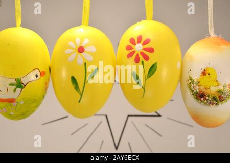 Four Easter eggs suspended in front of a brilliant star. Stock Photo