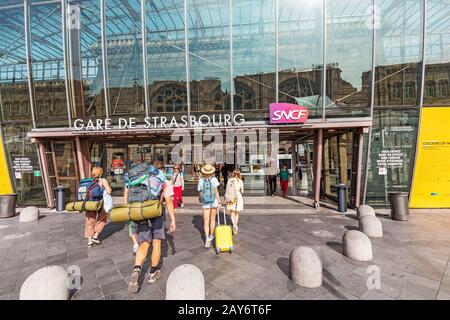 22 July 2019, Strasbourg, France: Two girl friends with baggage and suitcase heading to railway station in Strasbourg. Stock Photo