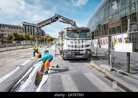 22 July 2019, Strasbourg, France: A team of workers repairing road in city center Stock Photo