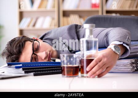 Young businessman drinking from stress Stock Photo