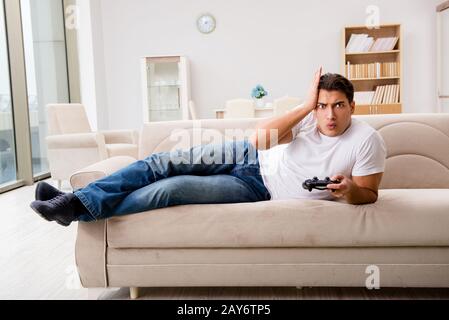 Man addicted to computer games Stock Photo