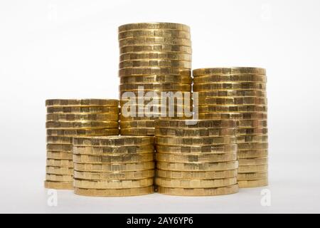 Five stacks of coins of different height on a white background Stock Photo