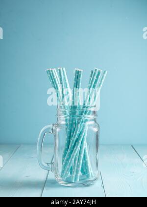 Mason jars with yellow paper straws and cap. Ideal for summer drinks and smoothies. Stock Photo