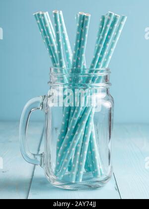 Mason jars with yellow paper straws and cap. Ideal for summer drinks and smoothies. Stock Photo