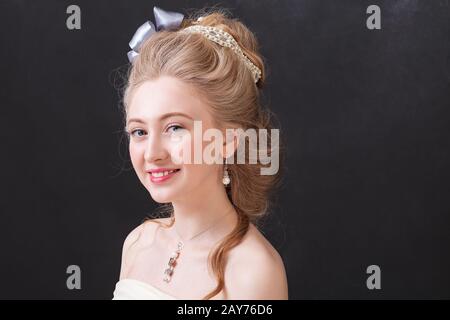 Woman in the Studio with a retro make-up and hairstyle in the style of painting by Thomas Gainsborough 'Lady in blue' (1780) Stock Photo