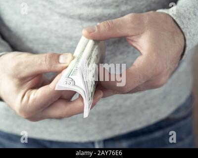 Hands counting dollars Stock Photo