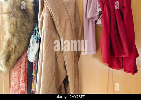 Pile of carelessly scattered clothes in wardrobe Stock Photo