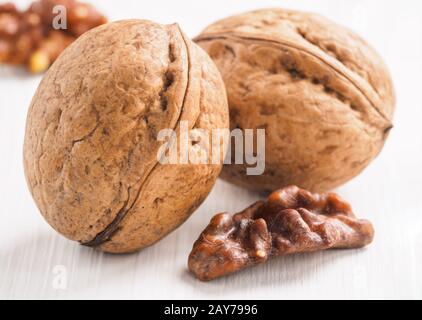 inshell walnut on white wooden background Stock Photo