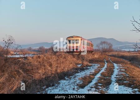 local train transporting workers in Romania, Transylvania in the winter Stock Photo