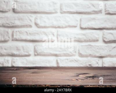 Empty wooden table over white brick wall. Background for product montage display Stock Photo