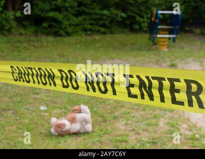 Police barricade in front of a crime scene on a playground Stock Photo