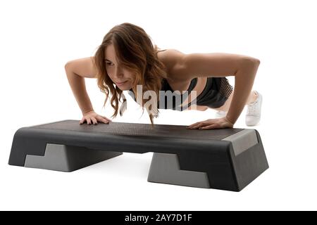 Woman doing push ups in studio isolated shot Stock Photo