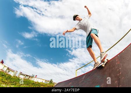 Young boy doing the trick on the ramp Stock Photo