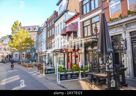 Venlo, Limburg, Netherlands - October 13, 2018: Street with cafes, restaurants, and bars in the historical center of the Dutch city. Traditional Dutch brick houses.