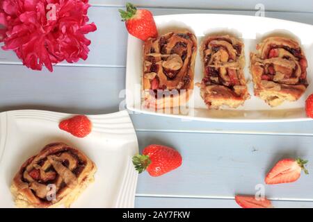 Strawberry buns with cinnamon. Yeast buns with strawberries. Yeast dough. Homemade pastries. A tasty and healthy snack. Stock Photo