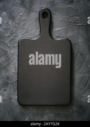 black wooden cutting board on black background Stock Photo