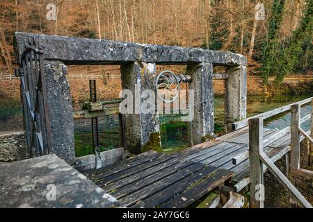 Old water gate for the hammermill at the karst spring 'Blautopf' in Blaubeuren. Stock Photo